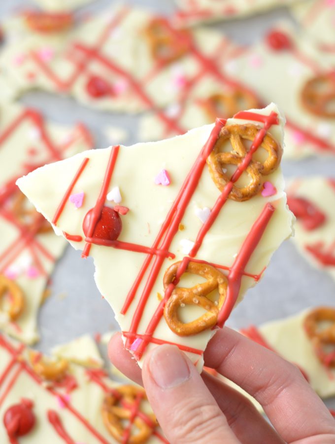 Super easy Valentine's Day Bark recipe. Made with white chocolate chips and 5 other ingredients, this is perfect for a last minute dessert idea.