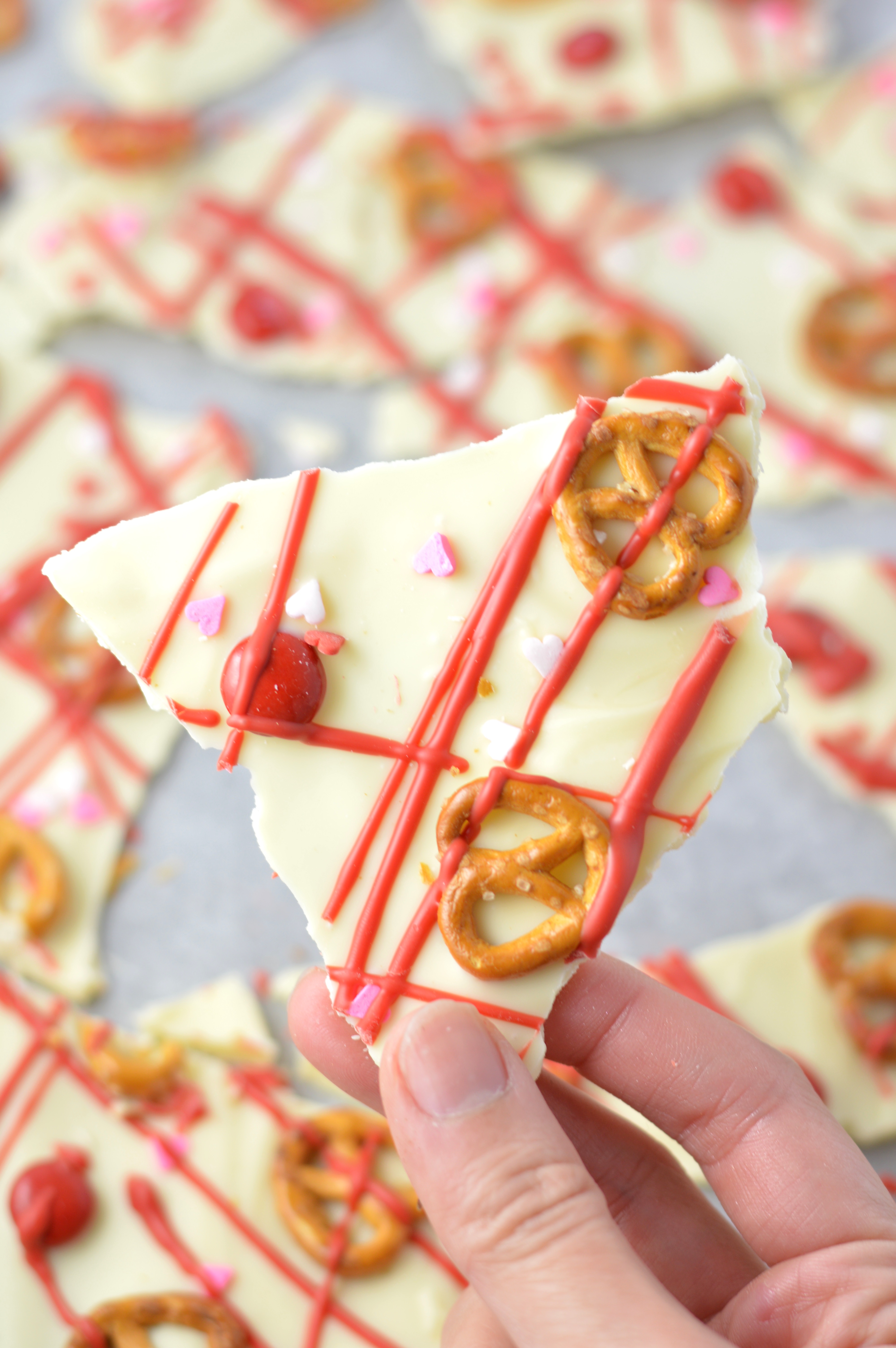 Super easy Valentine's Day Bark recipe. Made with white chocolate chips and 5 other ingredients, this is perfect for a last minute dessert idea.