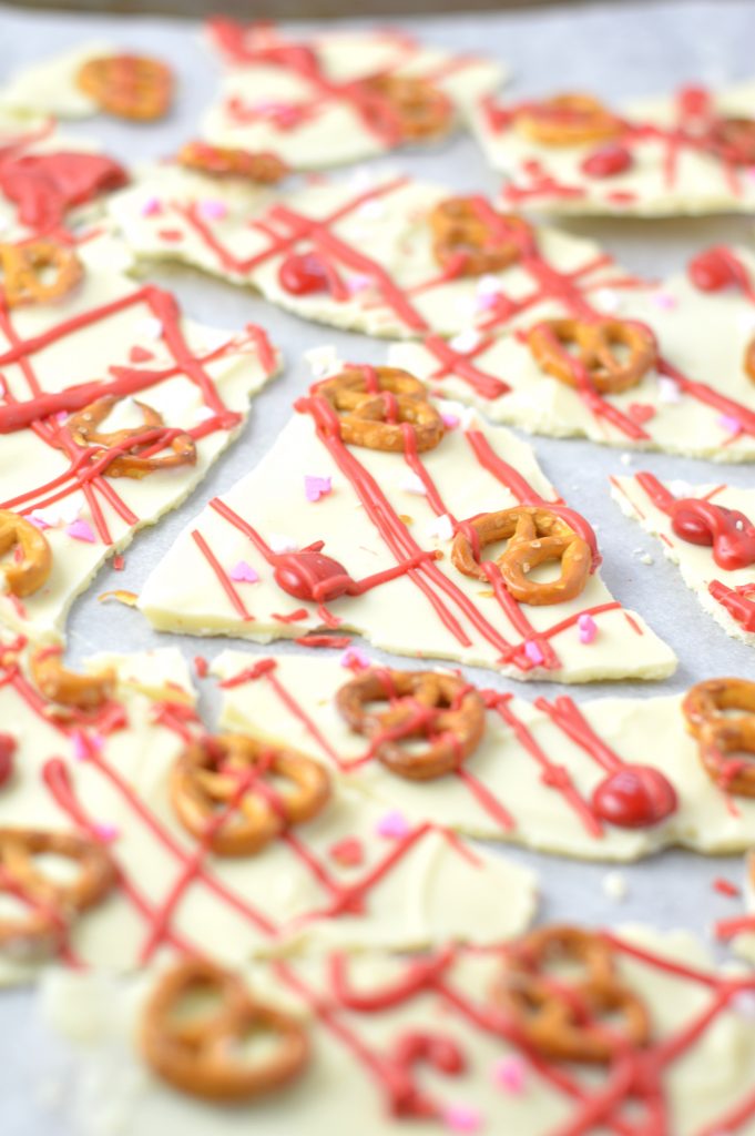 Super easy Valentine's Day Bark recipe. Made with white chocolate chips and 5 other ingredients, this is perfect for a last minute dessert idea.