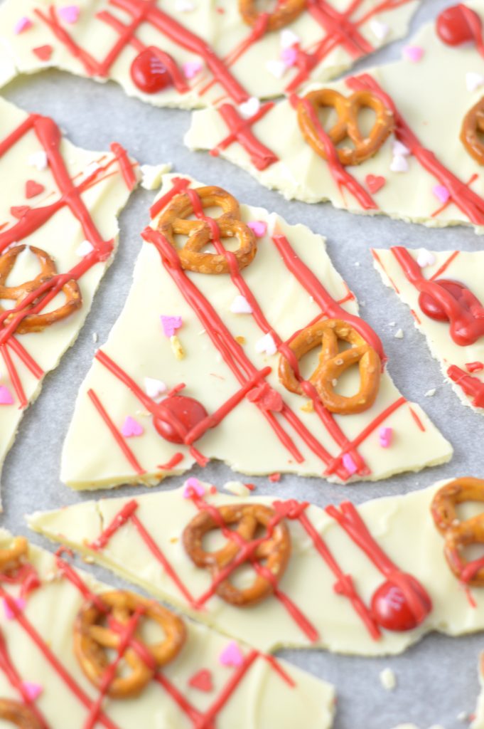 Super easy Valentine's Day Bark recipe. Made with white chocolate chips and 5 other ingredients, this is perfect for a last minute dessert idea.