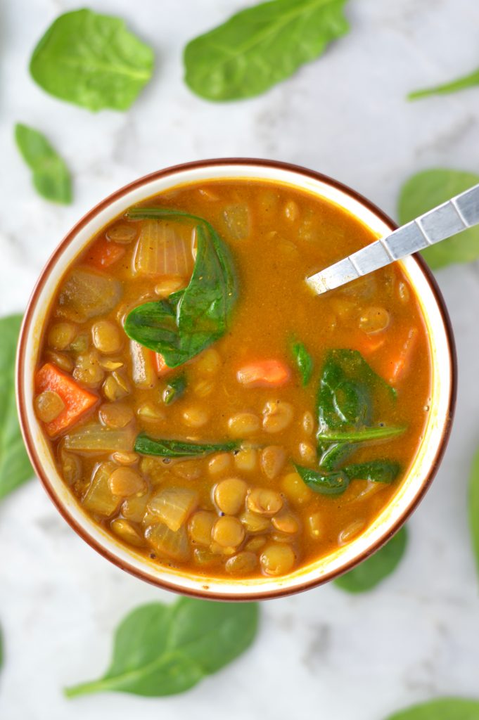 Easy Vegan Coconut Curry Lentil Soup recipe. Made with coconut milk and spinach, this makes a comforting meatless dinner idea.