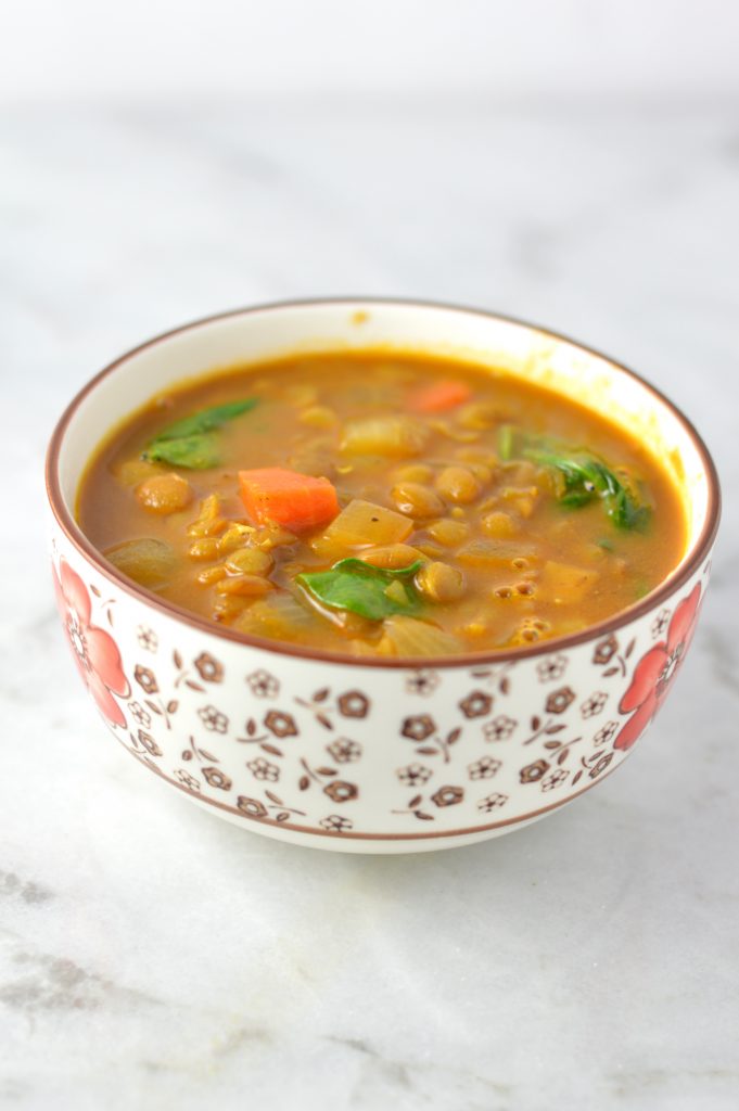 Easy Vegan Coconut Curry Lentil Soup recipe. Made with coconut milk and spinach, this makes a comforting meatless dinner idea.