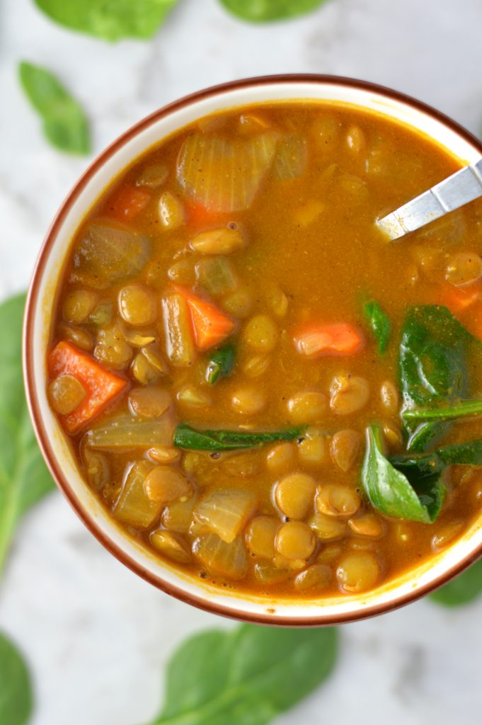 Easy Vegan Coconut Curry Lentil Soup recipe. Made with coconut milk and spinach, this makes a comforting meatless dinner idea.