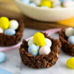 Almond Joy Easter Egg Nests with Mini Eggs and pastel ribbons beside them.