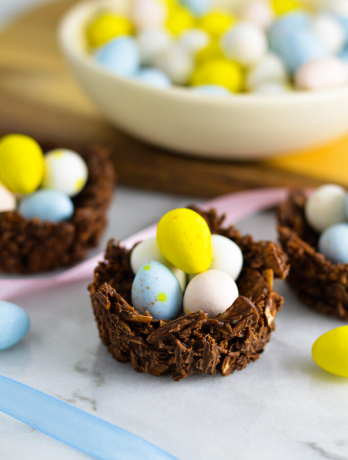 Almond Joy Easter Egg Nests with Mini Eggs and pastel ribbons beside them.