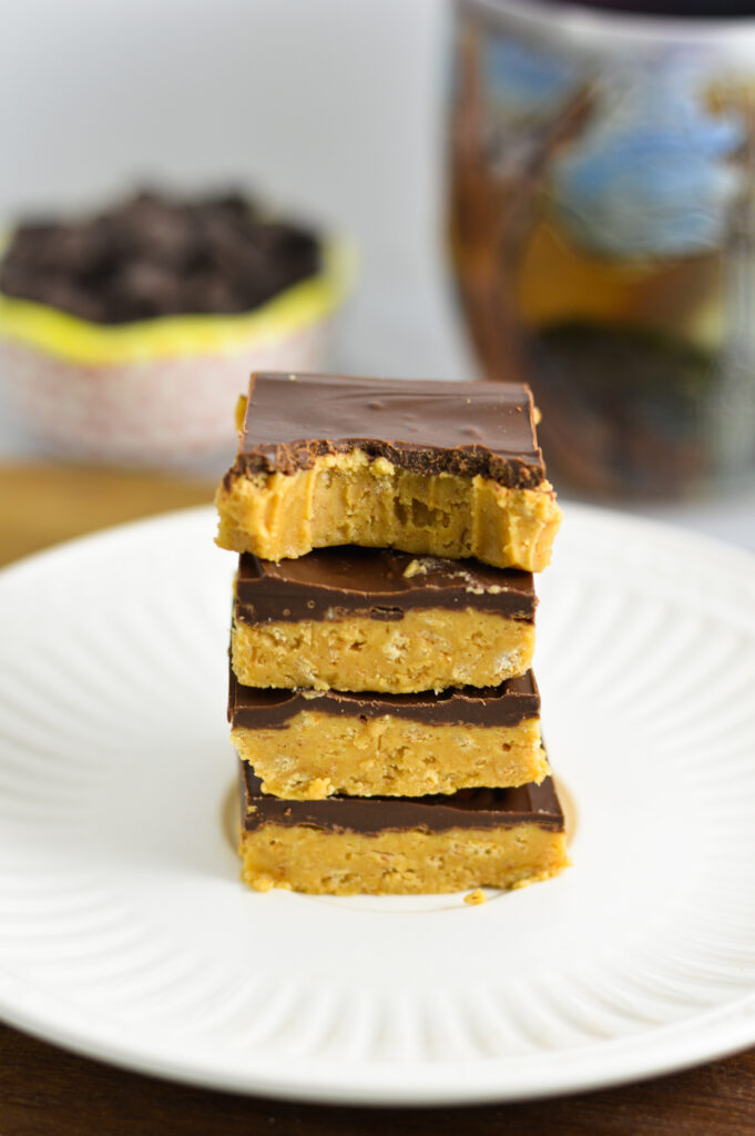 A stack of Chocolate Peanut Butter Squares with a bite taken out of the top bar.