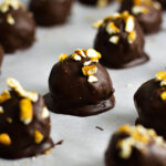 Crunchy Peanut Butter Pretzel Truffles on a baking sheet with parchment paper.