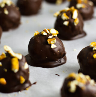 Crunchy Peanut Butter Pretzel Truffles on a baking sheet with parchment paper.