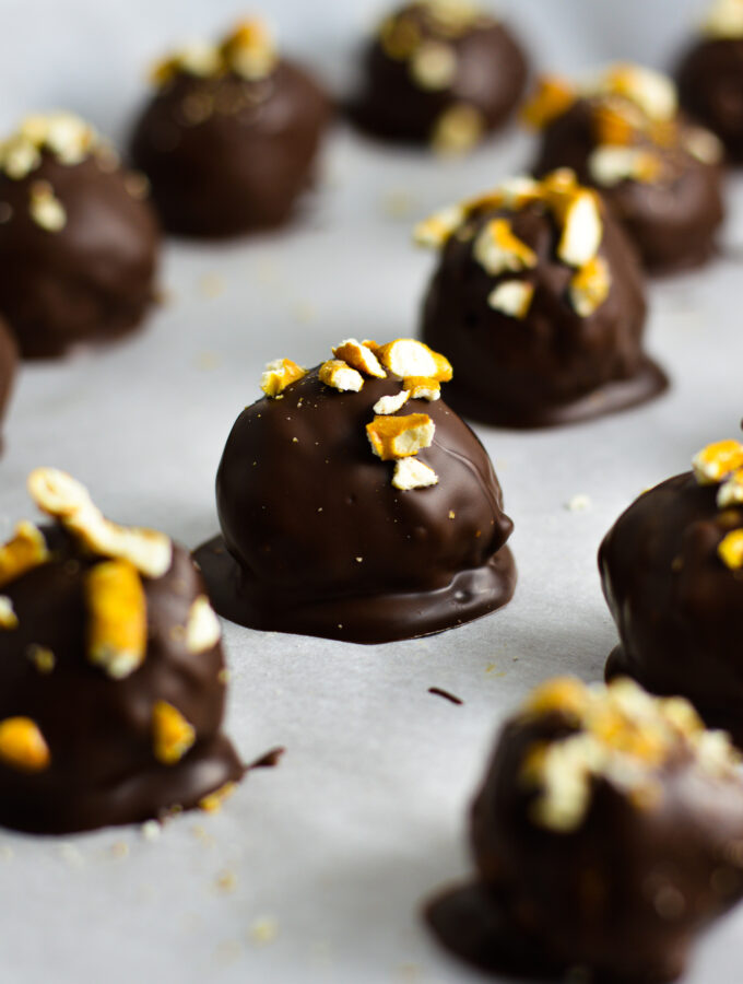 Crunchy Peanut Butter Pretzel Truffles on a baking sheet with parchment paper.