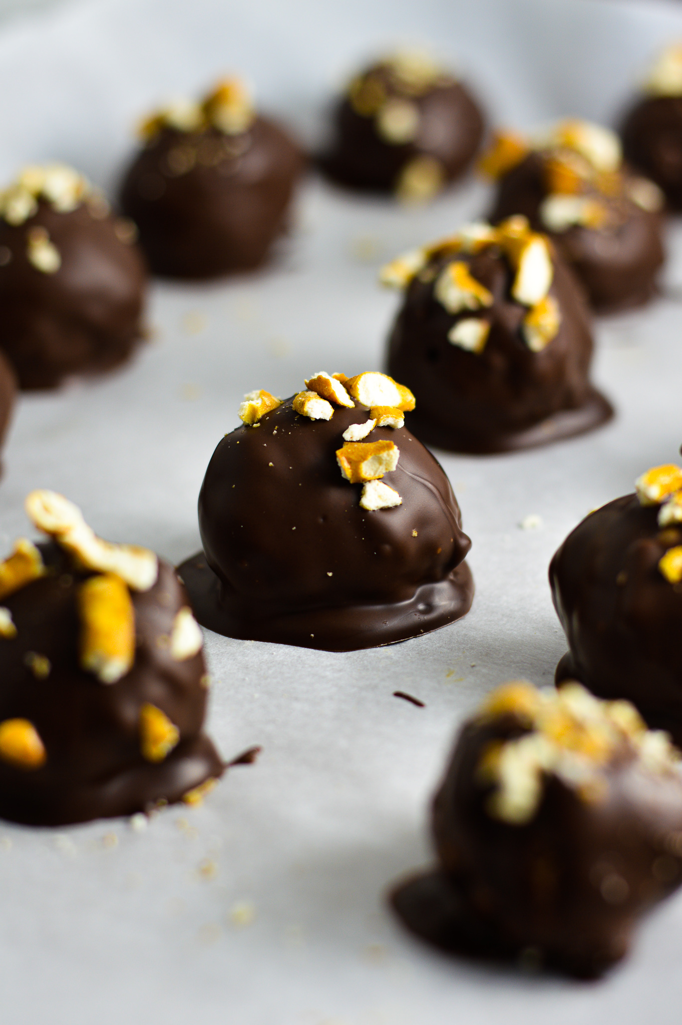 Crunchy Peanut Butter Pretzel Truffles on a baking sheet with parchment paper.