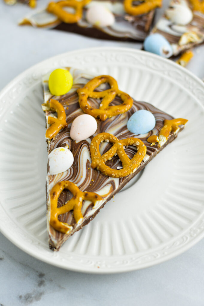 A triangular slice of Easter Bark on a white plate.