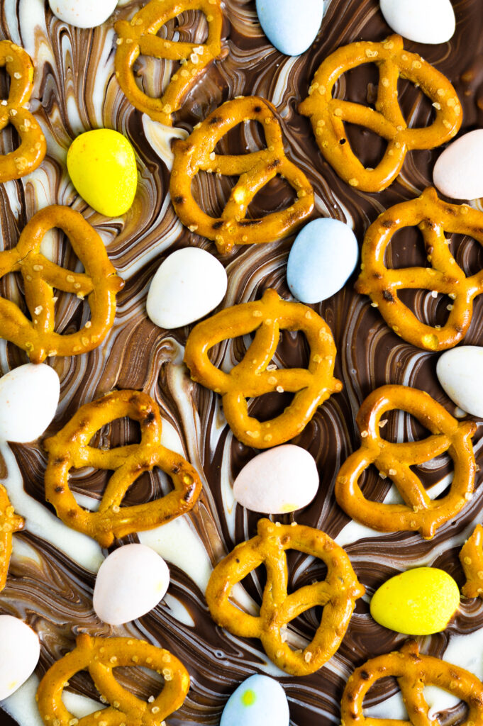 Unsliced slab of Easter Bark with chocolate eggs and crunchy pretzels.