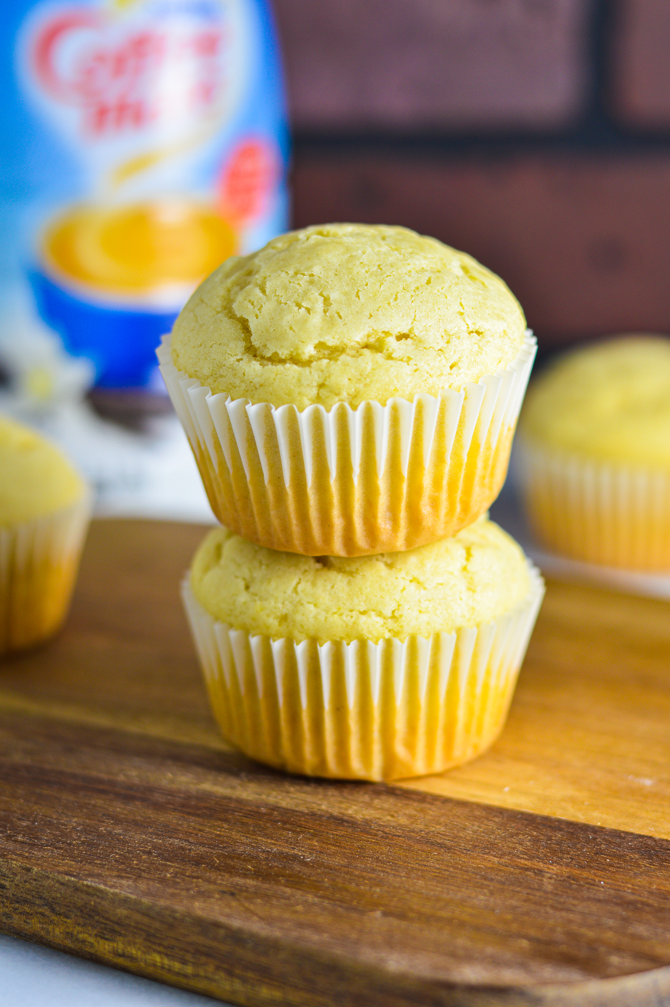 Two Vanilla Creamer Muffins stacked on top of each other.