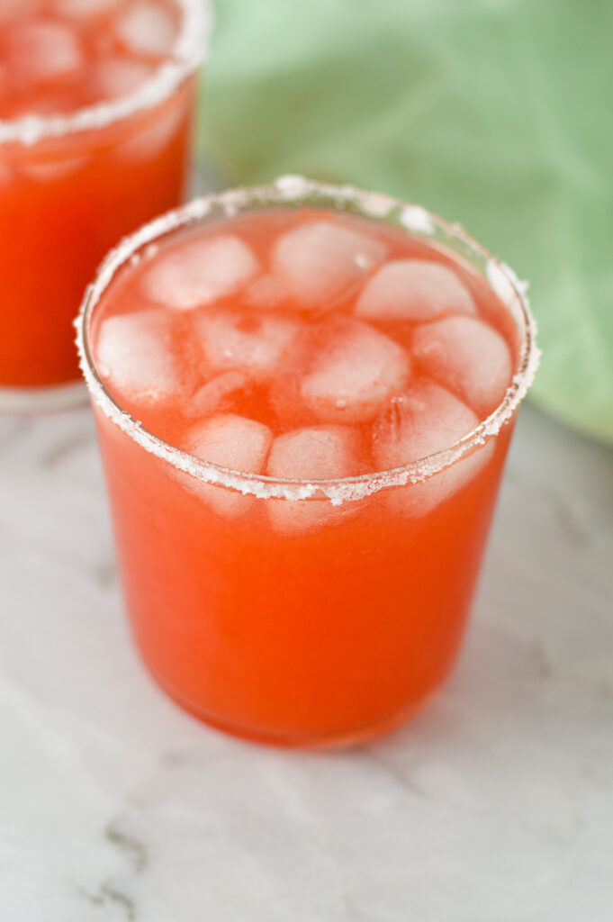 A couple of Watermelon flavored Margaritas with salt along the rim.