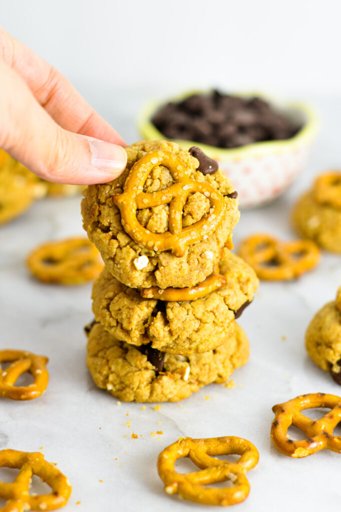 A hand taking the top Chubby Hubby Cookie from a stack of three.