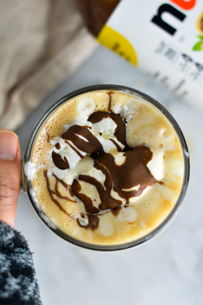 Overhead shot of Nutella Mocha with whipped cream and chocolate drizzle on top.