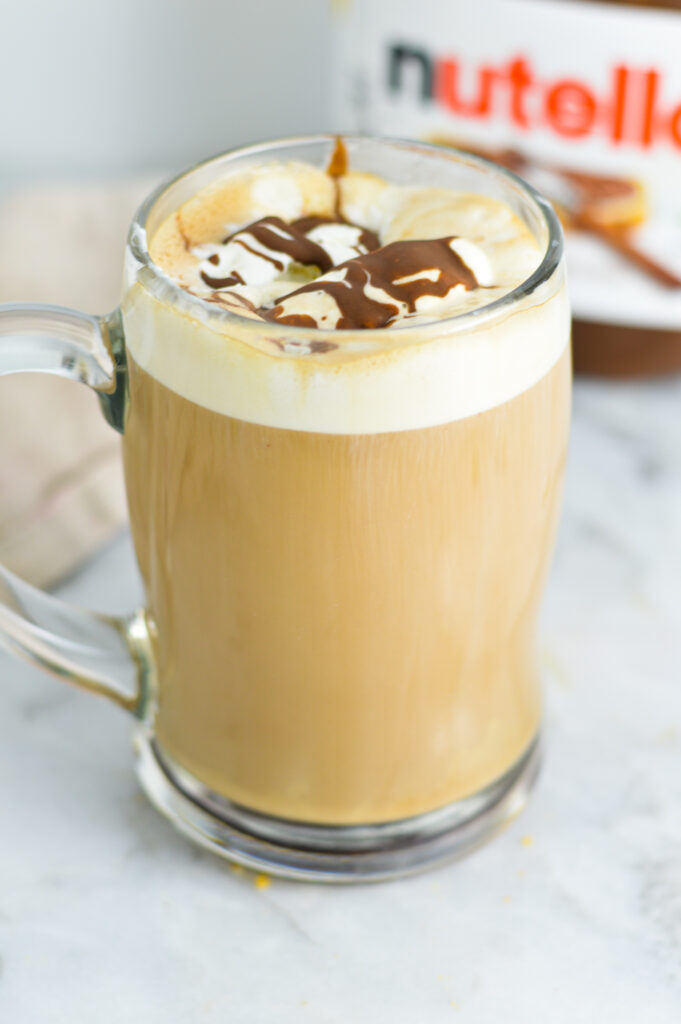 Nutella mocha in a large glass cup with a handle.