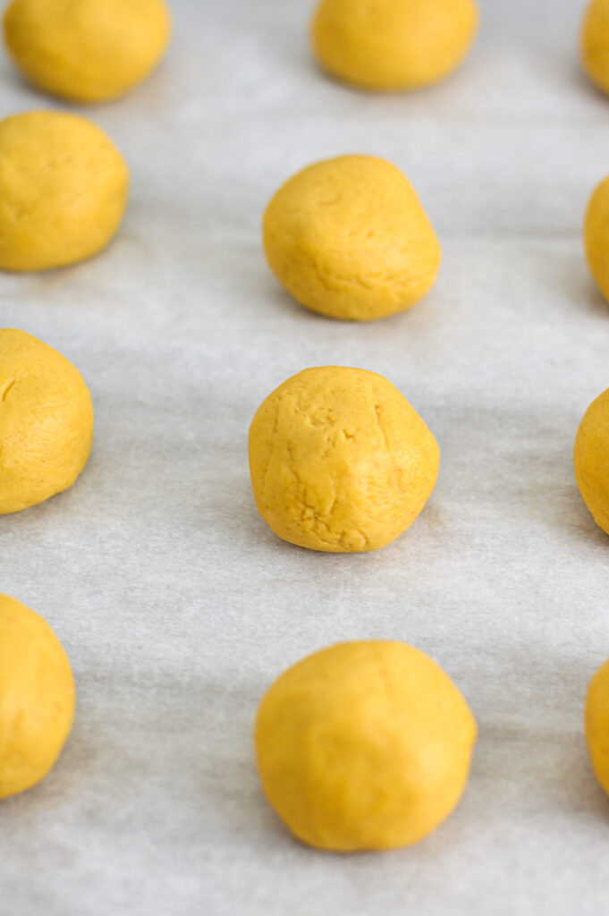 Peanut Butter Balls on a parchment paper lined baking sheet.