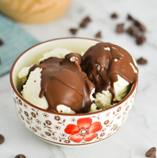 Vegan Magic Shell on vanilla bean ice cream in a small bowl.