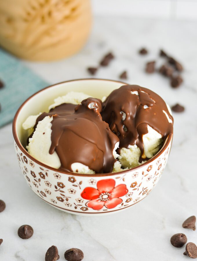 Vegan Magic Shell on vanilla bean ice cream in a small bowl.