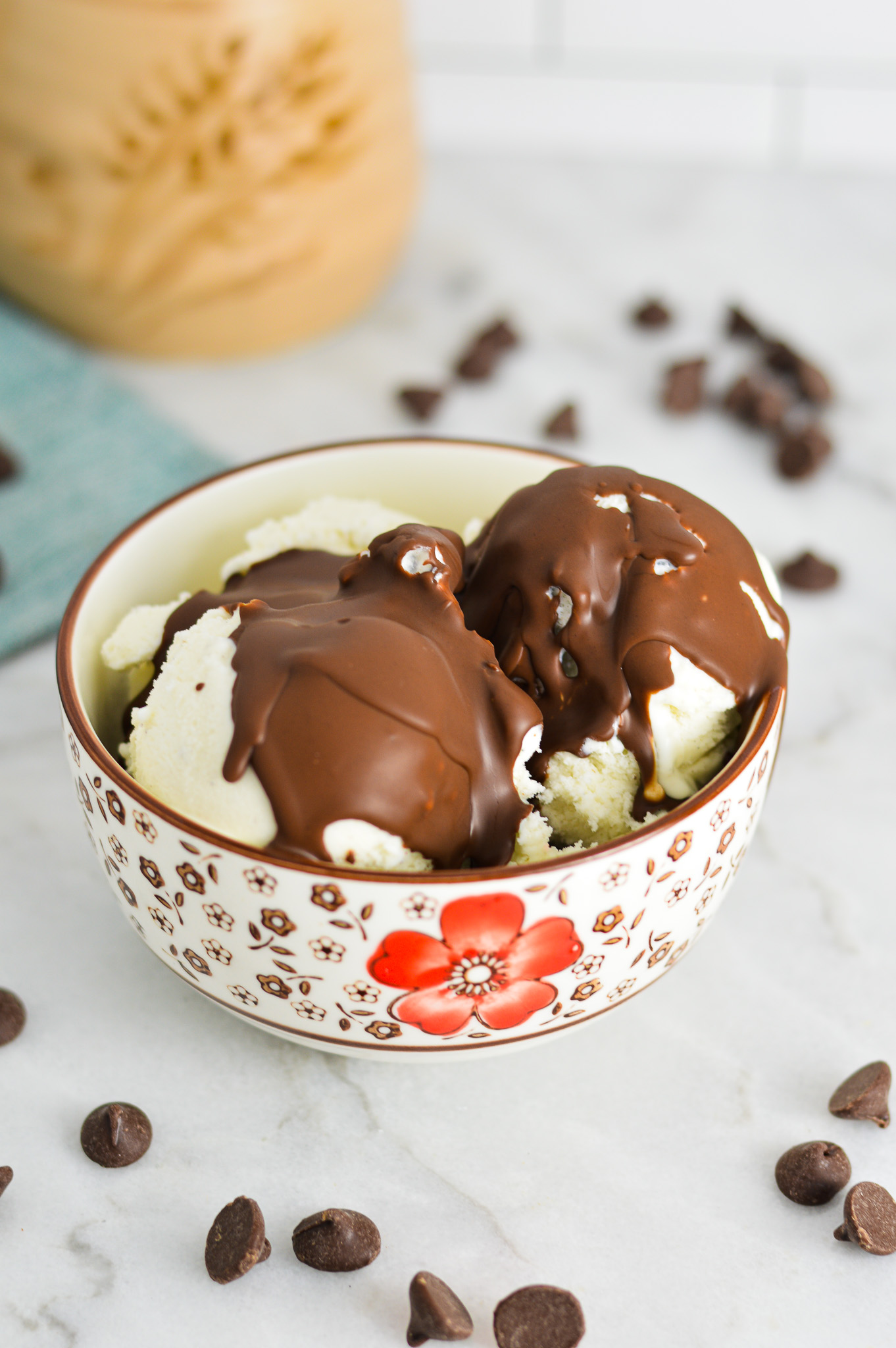 Vegan Magic Shell on vanilla bean ice cream in a small bowl.