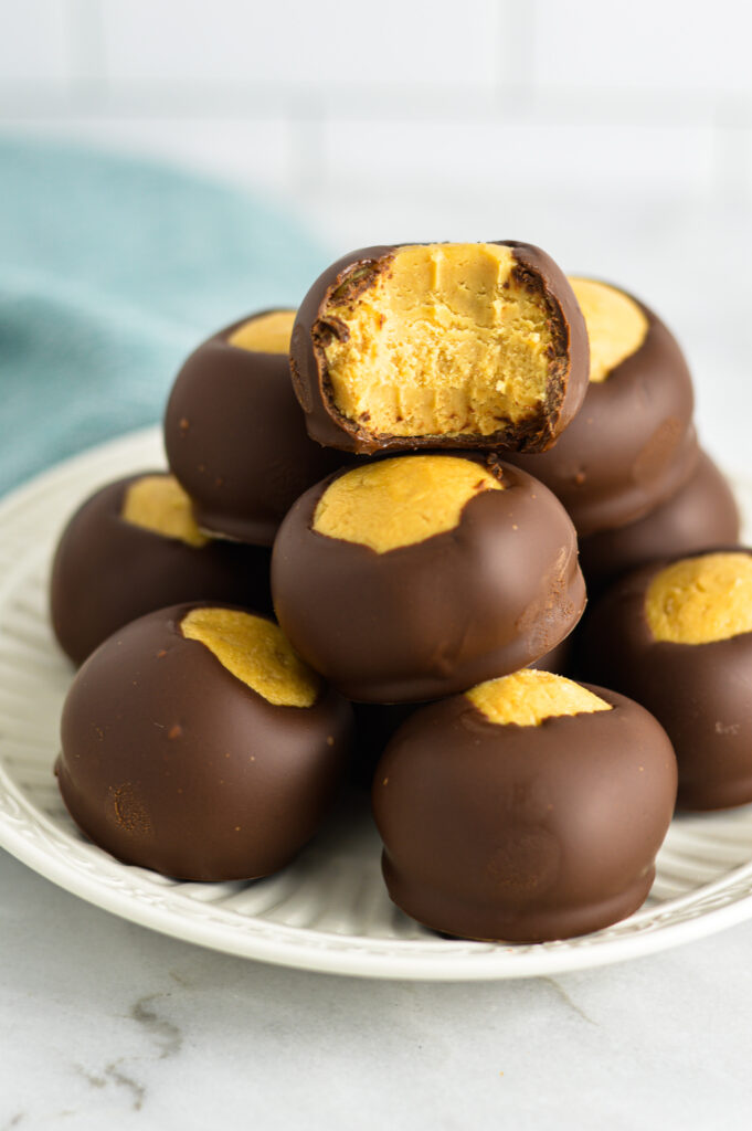 A stack of Buckeye truffles with a bite taken out of the top one.