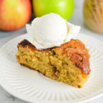 A slice of Dutch Apple Cake with a scoop of vanilla ice cream on top.