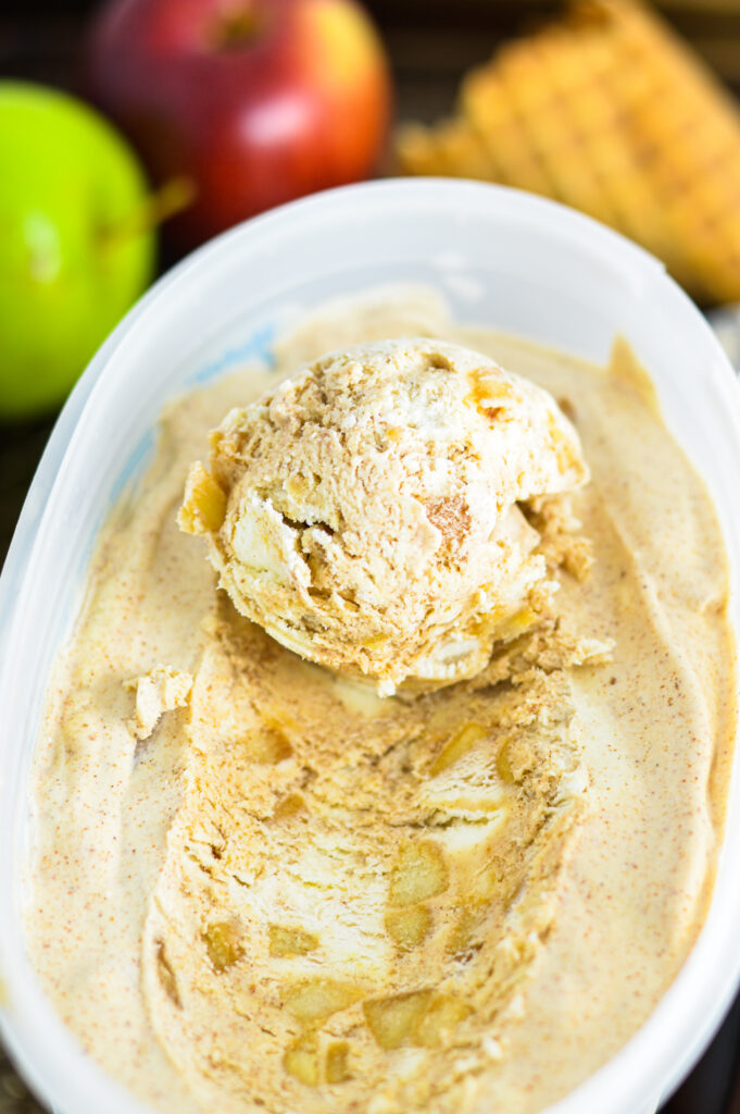 A large scoop of No Churn Apple Cinnamon Ice Cream in a large plastic container.