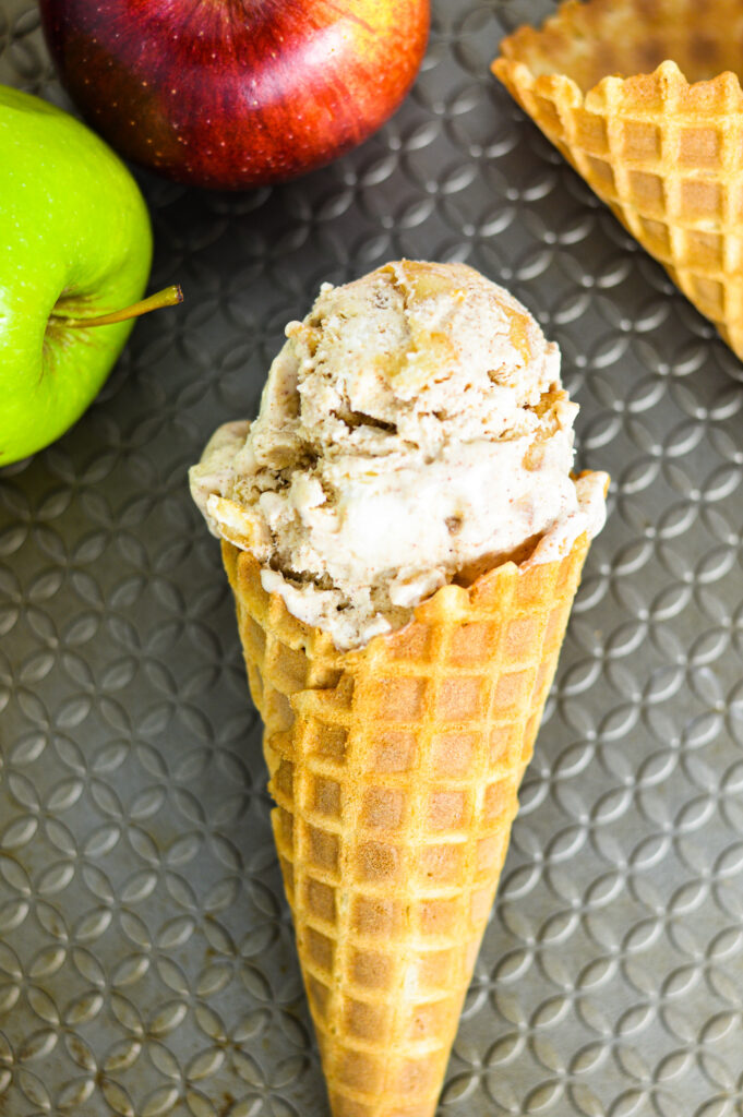 No Churn Apple Cinnamon Ice Cream in a waffle cone on a baking sheet.