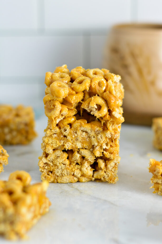 A stack of Peanut Butter Cheerio squares with a bite taken out of the top one.