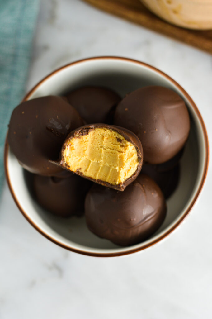 Overhead shot of Peanut Butter Truffles with a bite taken out of one.