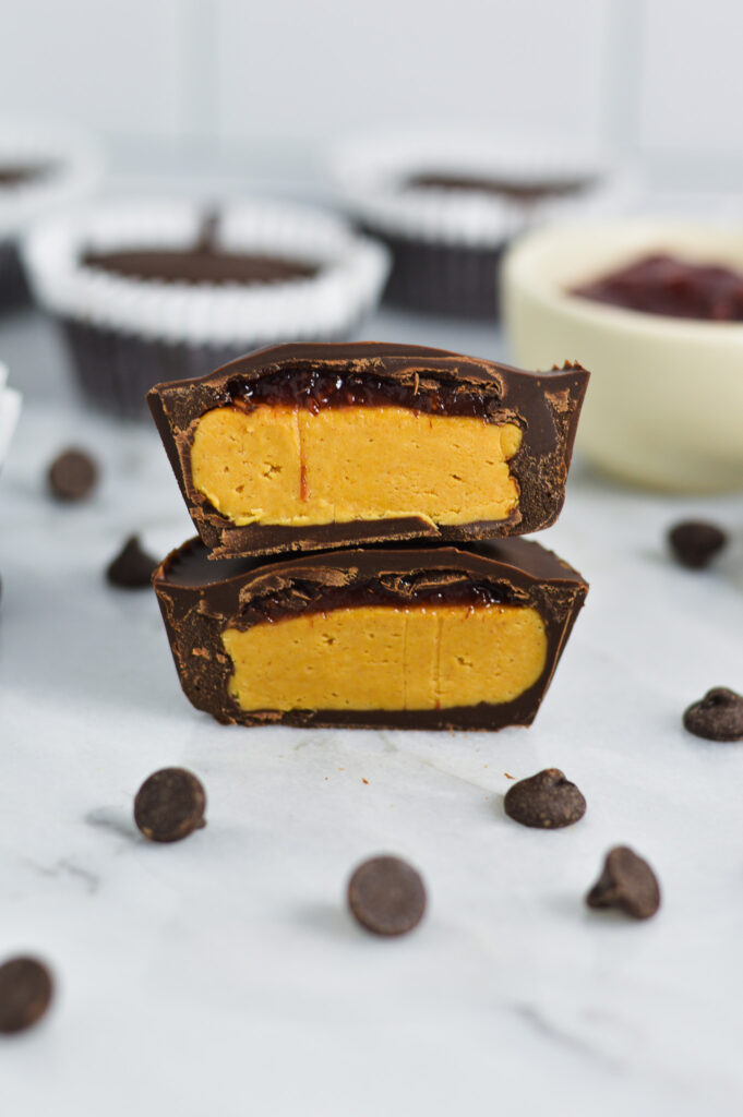 Peanut Butter and Jelly Chocolate Cups surrounded by semi-sweet chocolate chips.