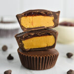 Peanut Butter and Jelly Chocolate Cups cut to reveal a creamy peanut butter filling and a thin jam layer on top.