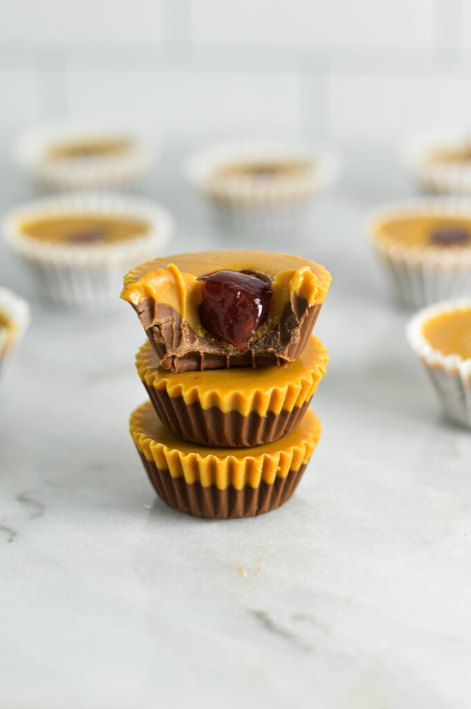 A stack of Peanut Butter and Jelly Nutella Cups with a bite taken out of the top chocolate cup.