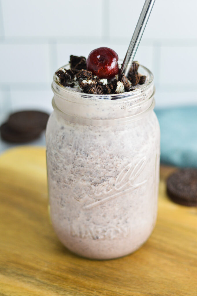 Cherry Oreo Milkshake topped with crushed Oreo cookies and a dark cherry.