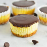 Creamy Mini Chocolate Ganache Cheesecakes with some cheesecakes without paper liners.