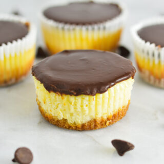 Creamy Mini Chocolate Ganache Cheesecakes with some cheesecakes without paper liners.