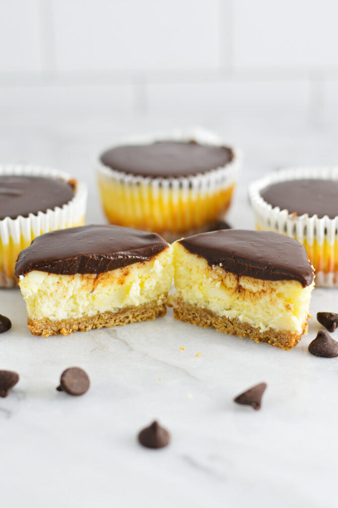 Chocolate Ganache Mini Cheesecakes with the front cheesecake cut in half.