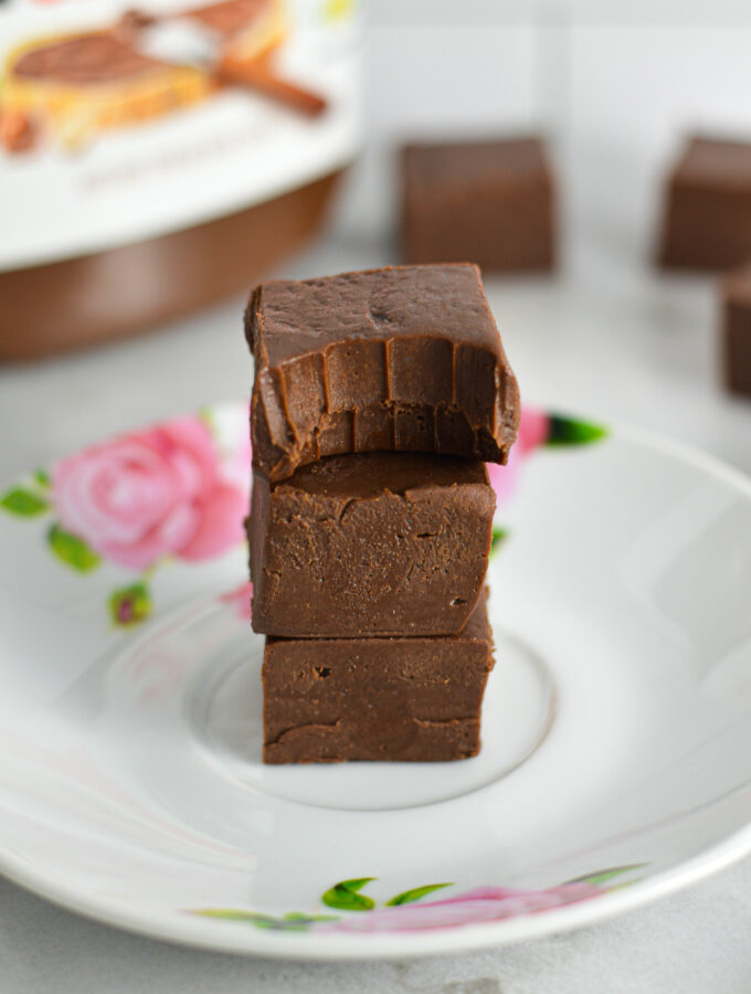 A stack of three Nutella Fudge with a bite taken out of the top one.