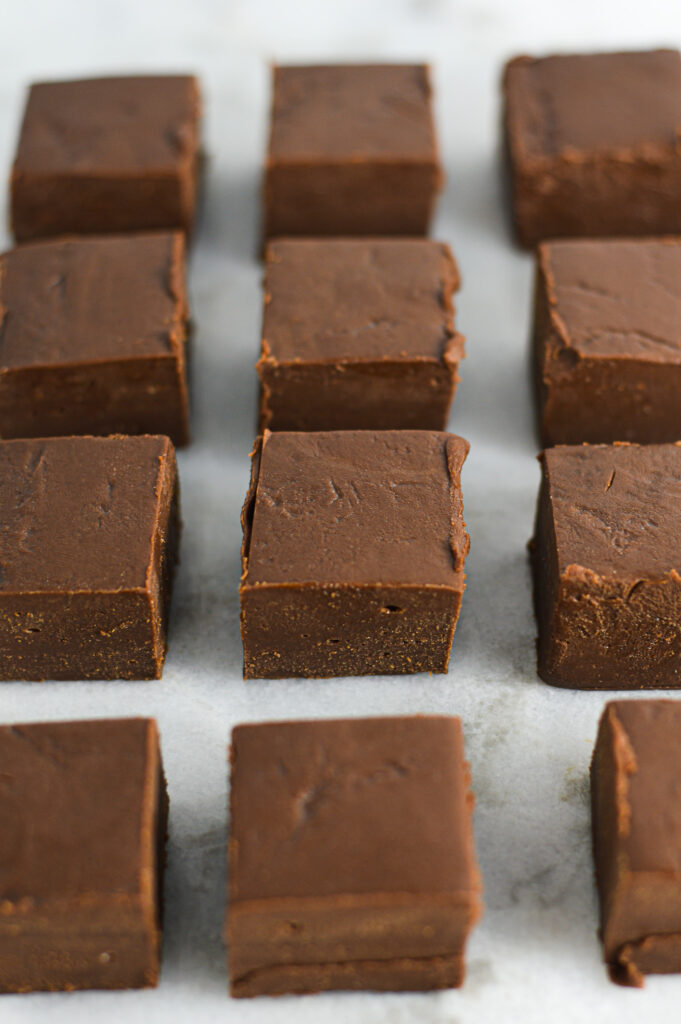 Nutella Fudge evenly spaced in a single layer on parchment paper.