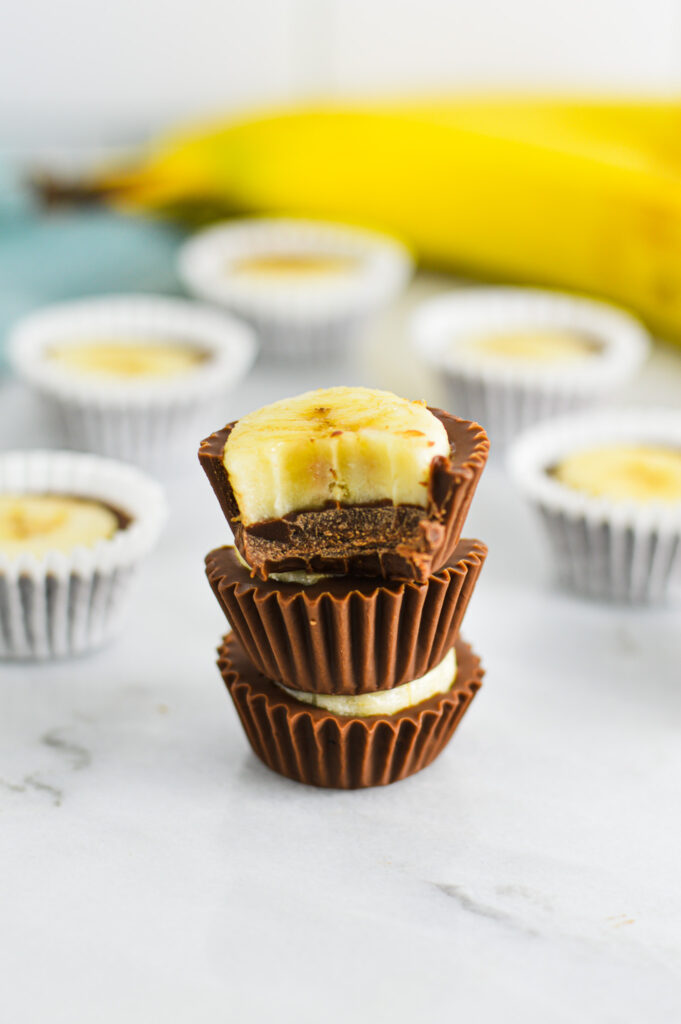 A stack of Banana Nutella Cups with a bite taken out of the top chocolate cup.