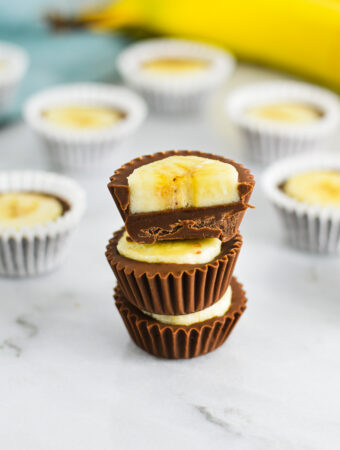 A stack of Banana Nutella Cups with the top Nutella Banana cup cut in half.