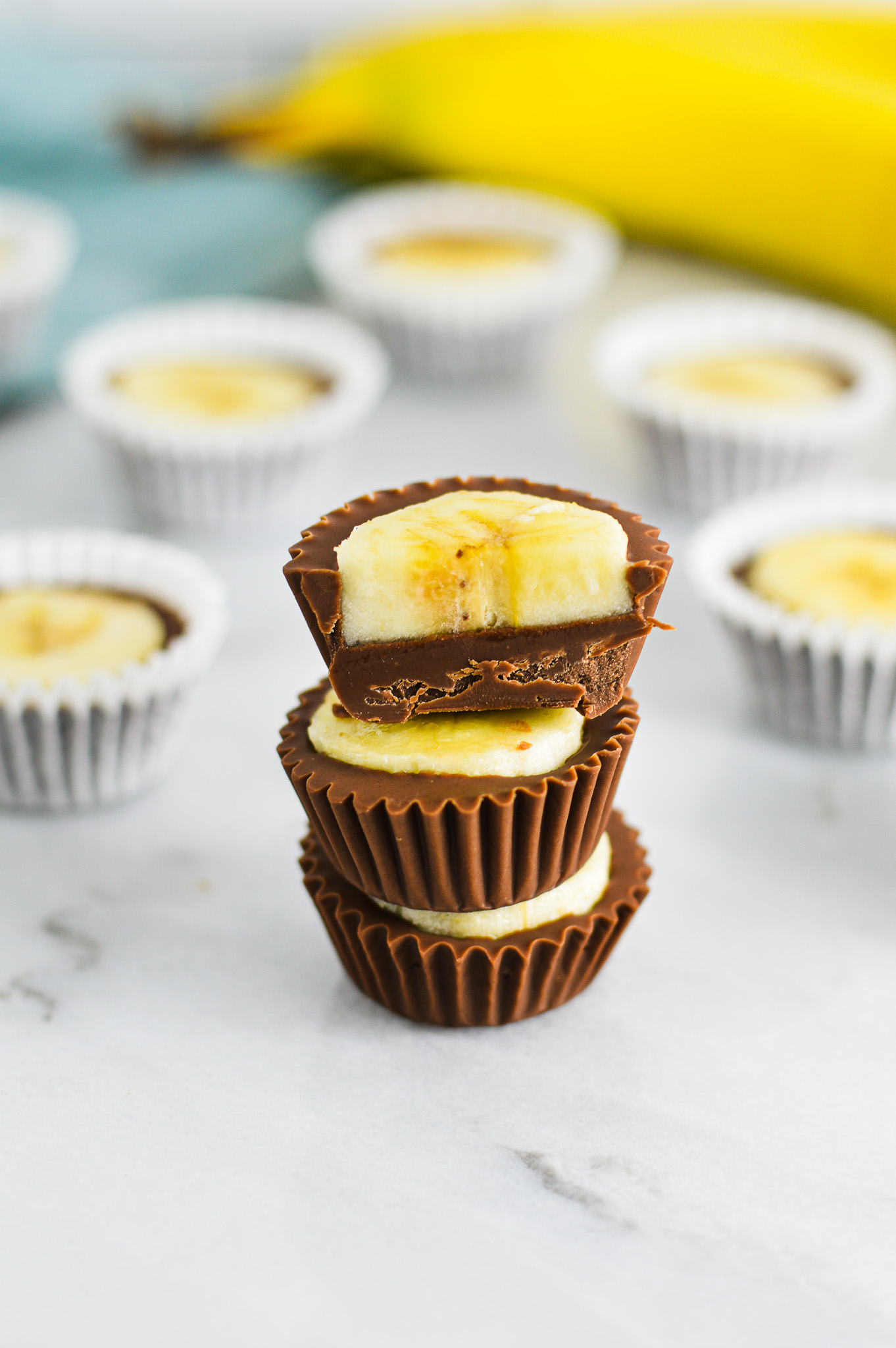 A stack of Banana Nutella Cups with the top Nutella Banana cup cut in half.