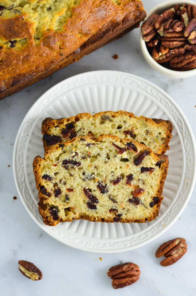 Sliced Cranberry Pecan Banana Bread on a small white plate.