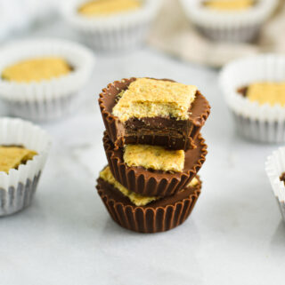 A stack of soft and crunchy Graham Cracker Nutella Cups with a bite taken out of the top one, revealing a creamy filling.