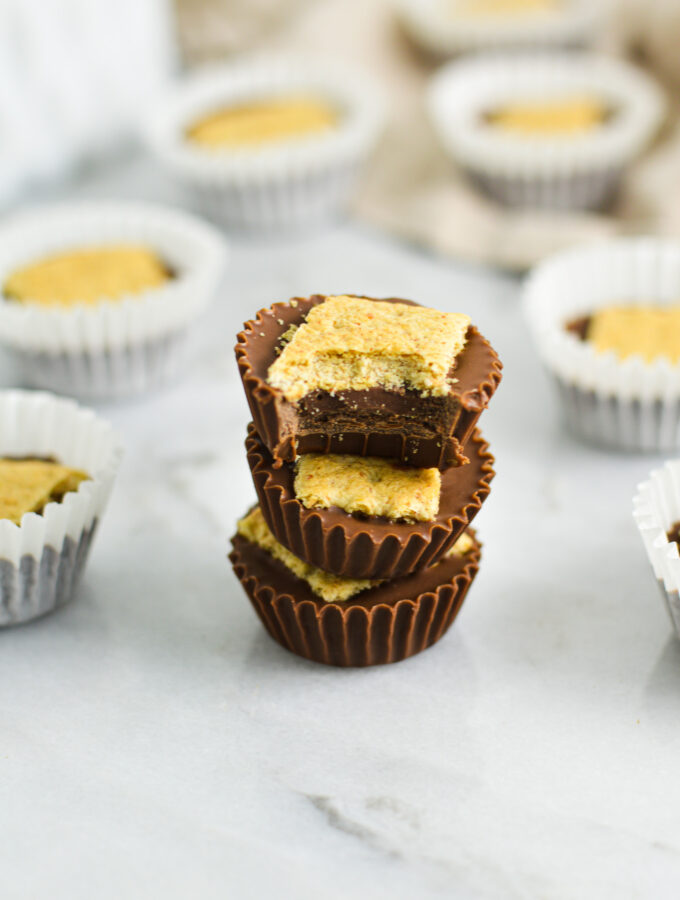 A stack of soft and crunchy Graham Cracker Nutella Cups with a bite taken out of the top one, revealing a creamy filling.