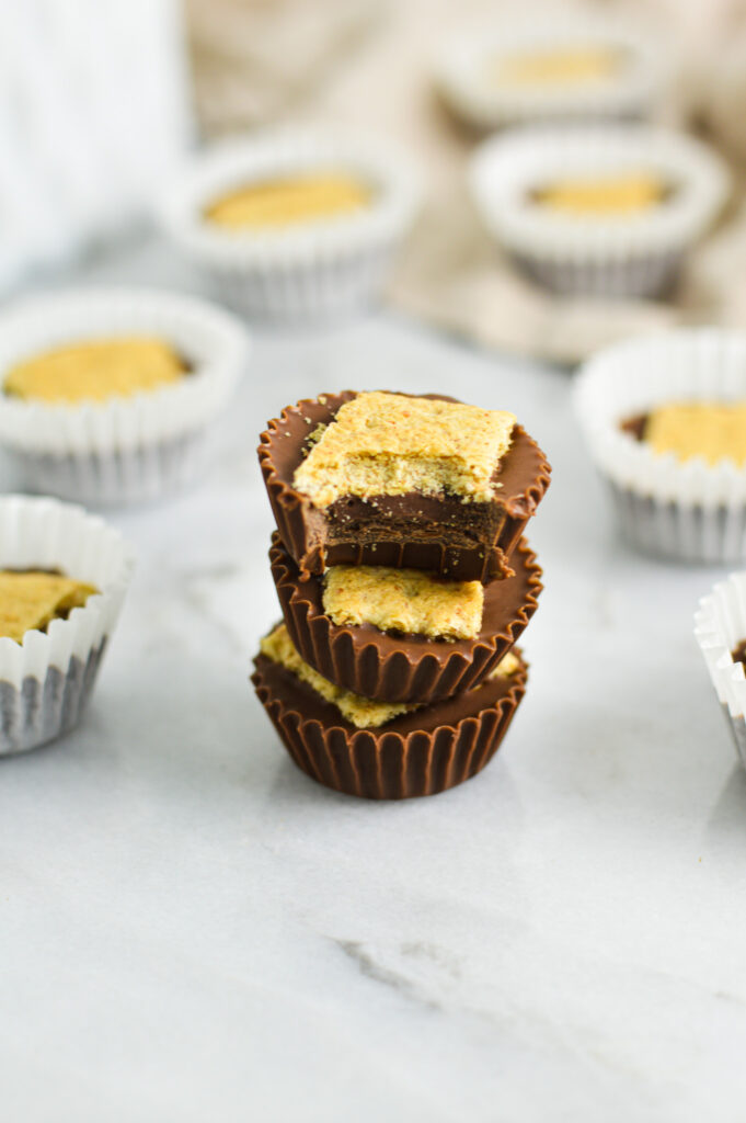 A stack of soft and crunchy Graham Cracker Nutella Cups with a bite taken out of the top one, revealing a creamy filling.