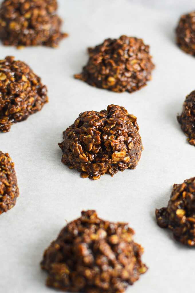 No Bake Nutella Oatmeal Cookies evenly spaced on a parchment paper lined cookie sheet.