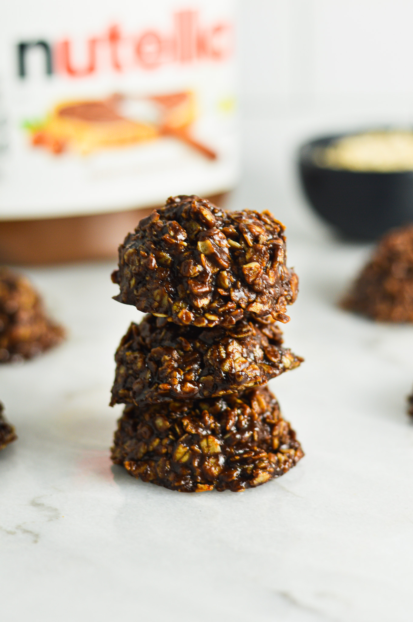 A stack of No Bake Nutella Oatmeal Cookies on a granite surface.