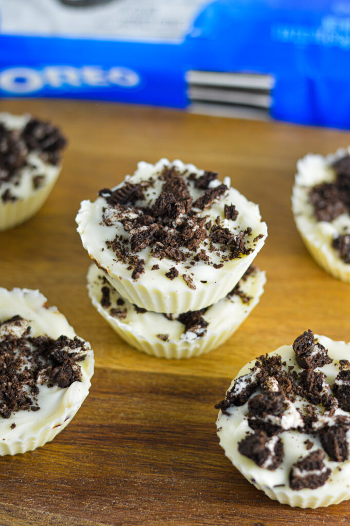 Two Nutella Stuffed Oreo Cups topped with crumbled Oreo cream filled cookies.